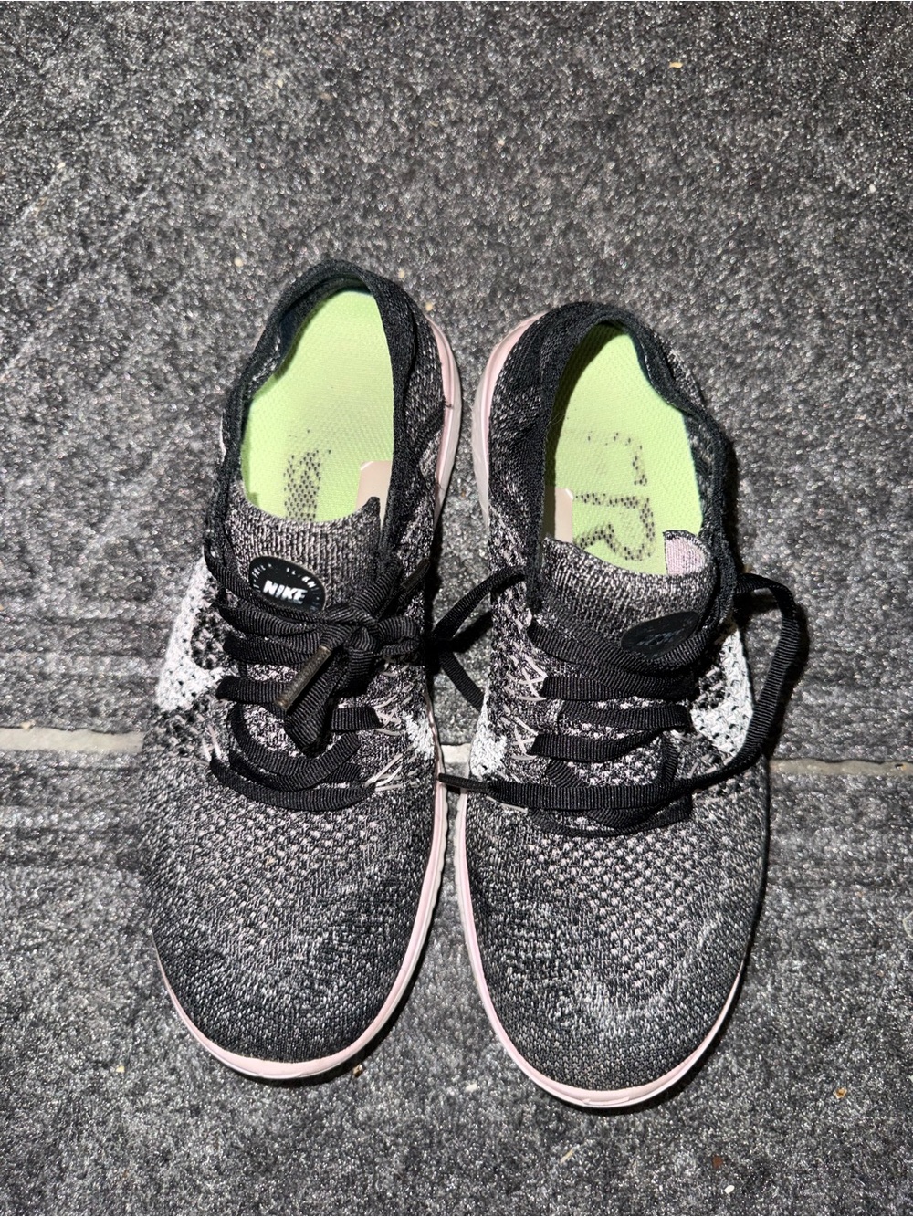Nike Womenโs Black Knit Athletic Sneakers with Pink Accents